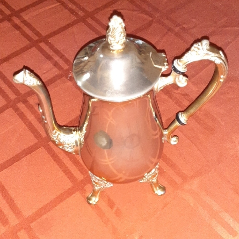 Elegant Silver Teapot with Ornate Design